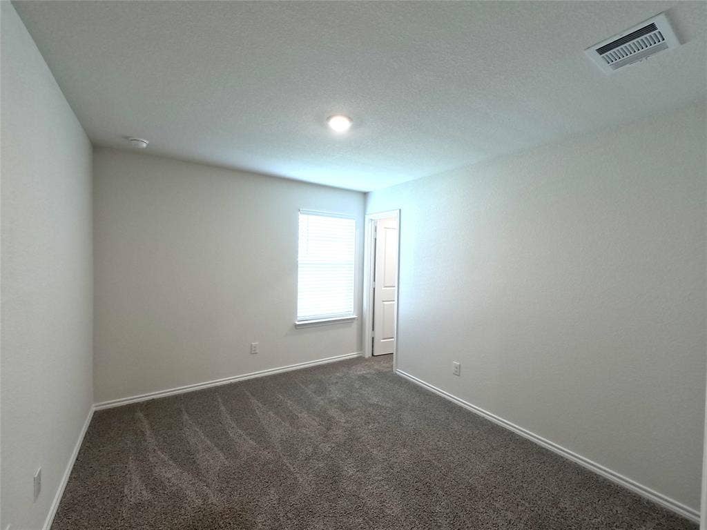 1148 Samantha Drive, Dallas, TX 75253 Carpeted room featuring a single window, recessed lighting, and a paneled door