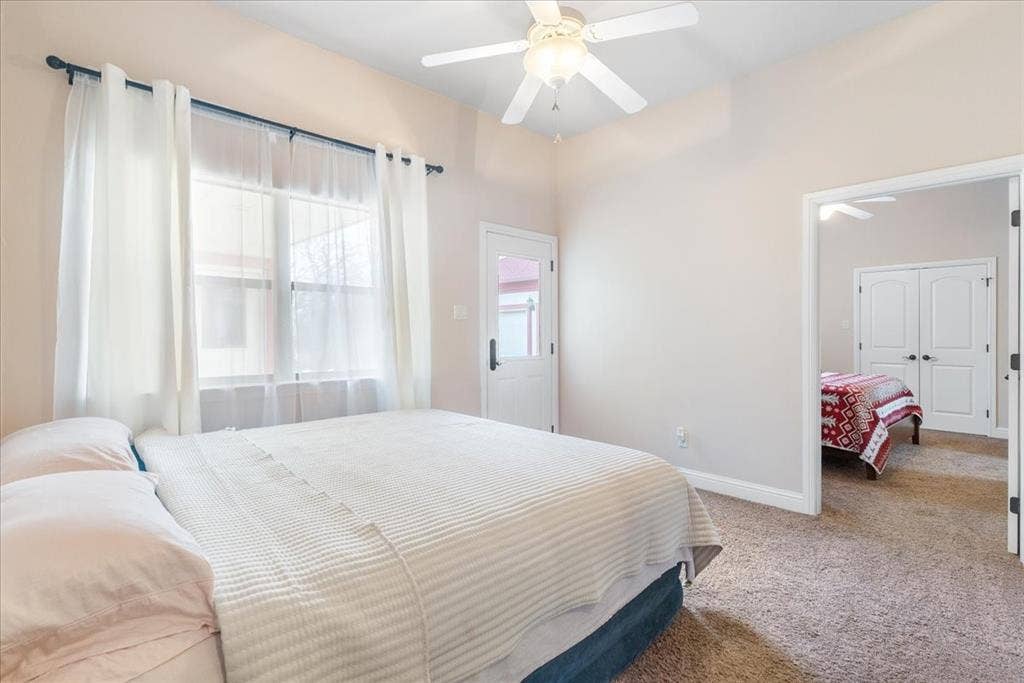 117 Redtail Court, Weatherford, TX 76088 Vaulted ceiling with integrated ceiling fan, carpeted flooring, and exterior glass-panel door