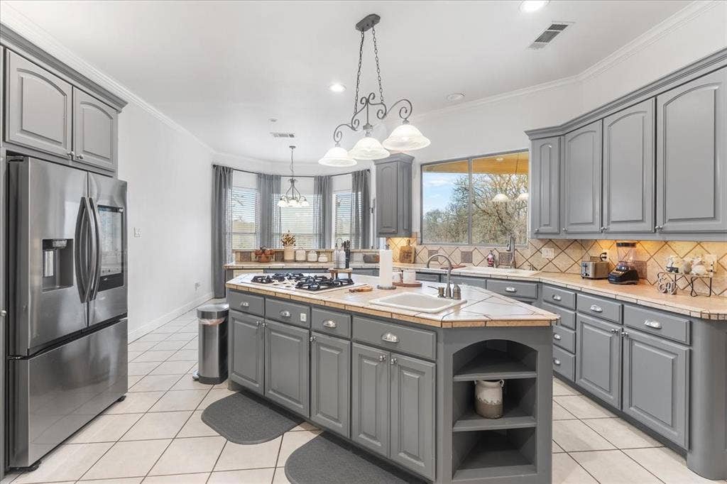 117 Redtail Court, Weatherford, TX 76088 Kitchen featuring grey cabinetry, a central island with a built-in cooktop, tile countertops, recessed lighting, and stainless steel appliances