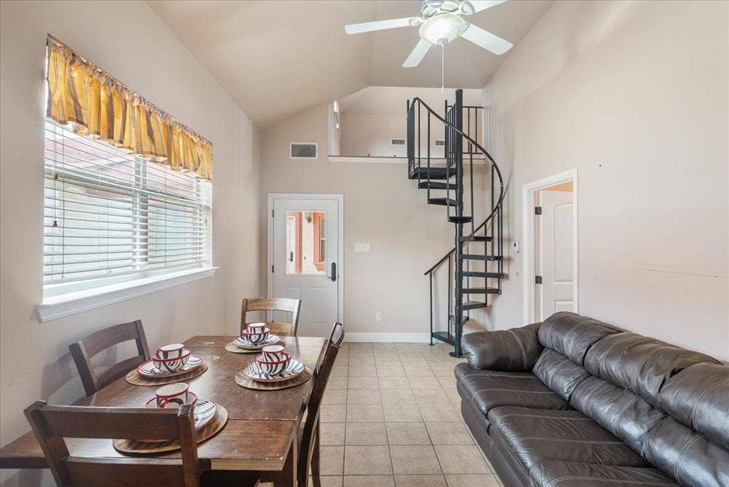 117 Redtail Court, Weatherford, TX 76088 Guest House. Vaulted ceilings with ceiling fan, tile flooring, and a black spiral staircase
