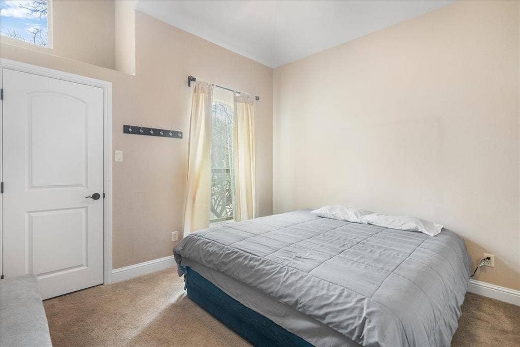 117 Redtail Court, Weatherford, TX 76088 Guest House. Arched panel interior door, neutral carpeting, and a window with natural light