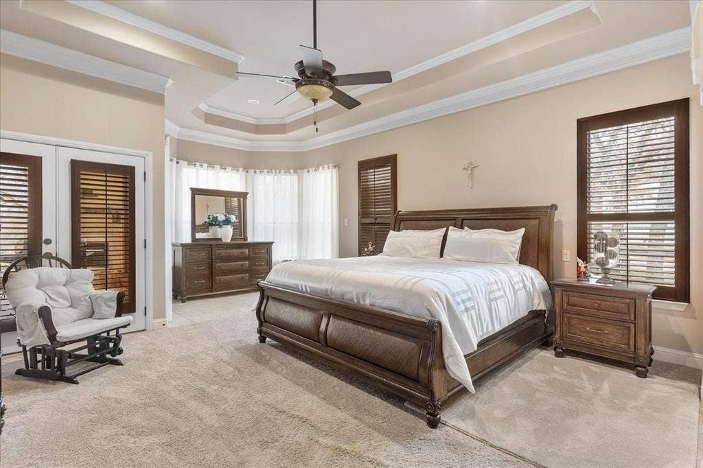 117 Redtail Court, Weatherford, TX 76088 Tray ceiling with crown molding, ceiling fan, carpeted flooring, and dark wood-finish plantation shutters