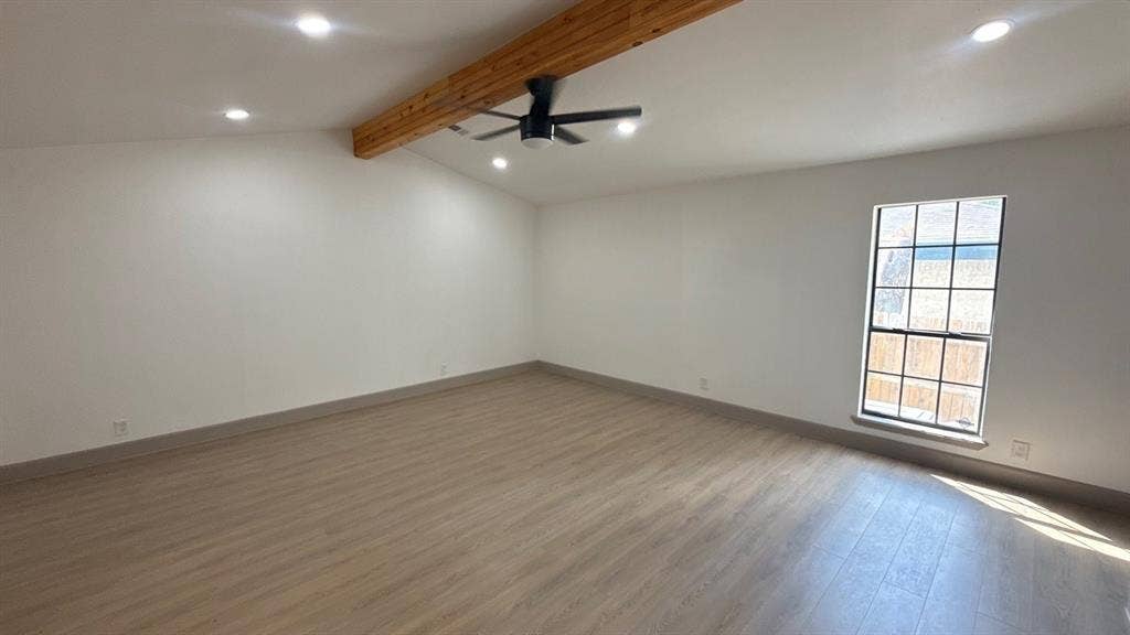 7437 Eccles Drive, Dallas, TX 75227 Vaulted ceiling featuring an exposed wood-finish beam, wood-finish flooring, recessed lighting, and a multi-pane window