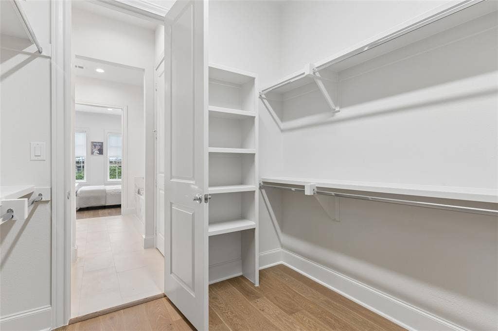 2401 Canton Street, #1002, Dallas, TX 75201 Primary bedroom offers a huge walk-in closet. Image of model home with similar layout.