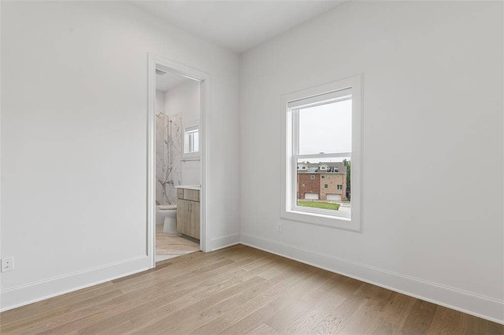2401 Canton Street, #1002, Dallas, TX 75201 Third floor guest bedroom features an ensuite bathroom. Image of model home with similar layout.
