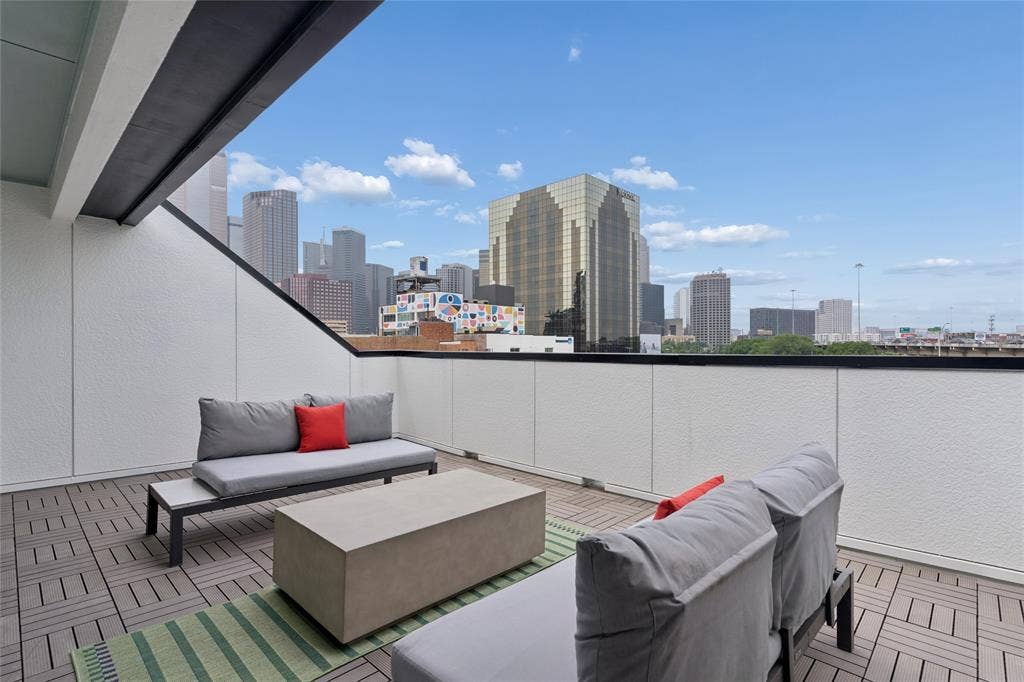 2401 Canton Street, #1002, Dallas, TX 75201 Private roof deck with views of the Dallas skyline. Image of model home with similar layout.