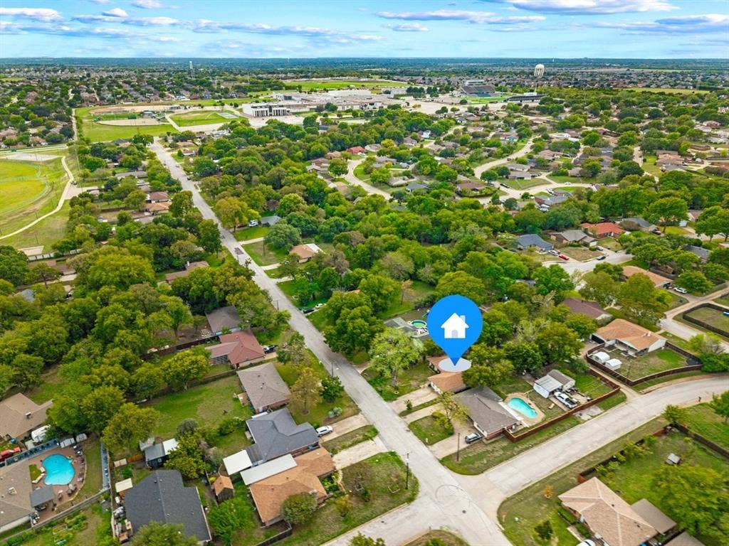 203 Evelyn Street, DeSoto, TX 75115 Aerial perspective featuring mature trees situated within a suburban neighborhood