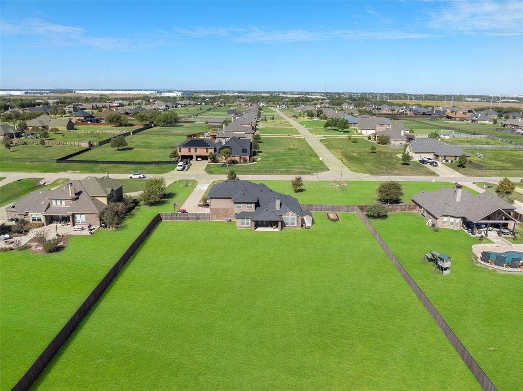 13176 Franklin Lane, Talty, TX 75126 Aerial perspective featuring an expansive fenced backyard with a sprawling lawn and a covered rear patio