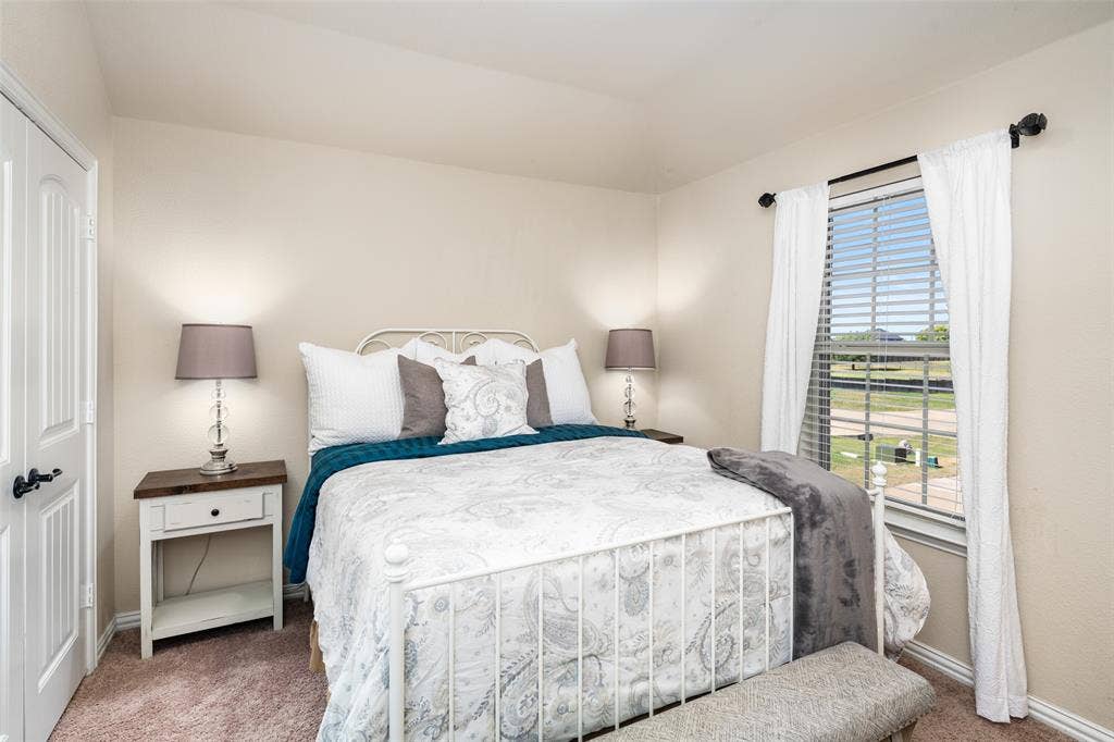 13176 Franklin Lane, Talty, TX 75126 Neutral interior walls, wall-to-wall carpeting, and a single window with horizontal blinds and hardware