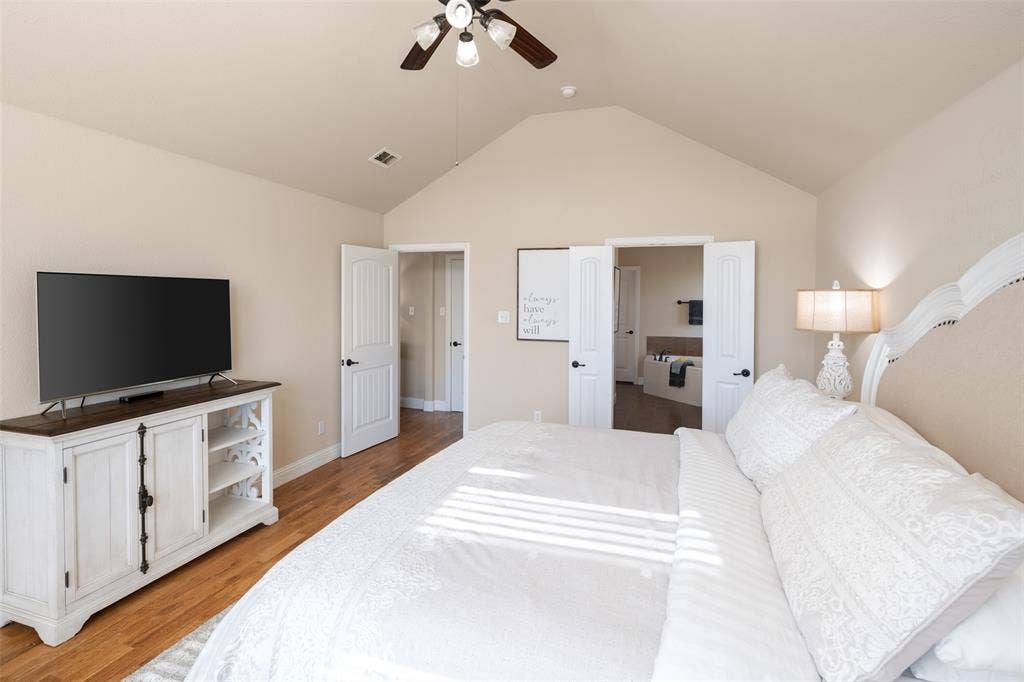 13176 Franklin Lane, Talty, TX 75126 Vaulted ceiling with an integrated multi-light ceiling fan and wood-finish flooring