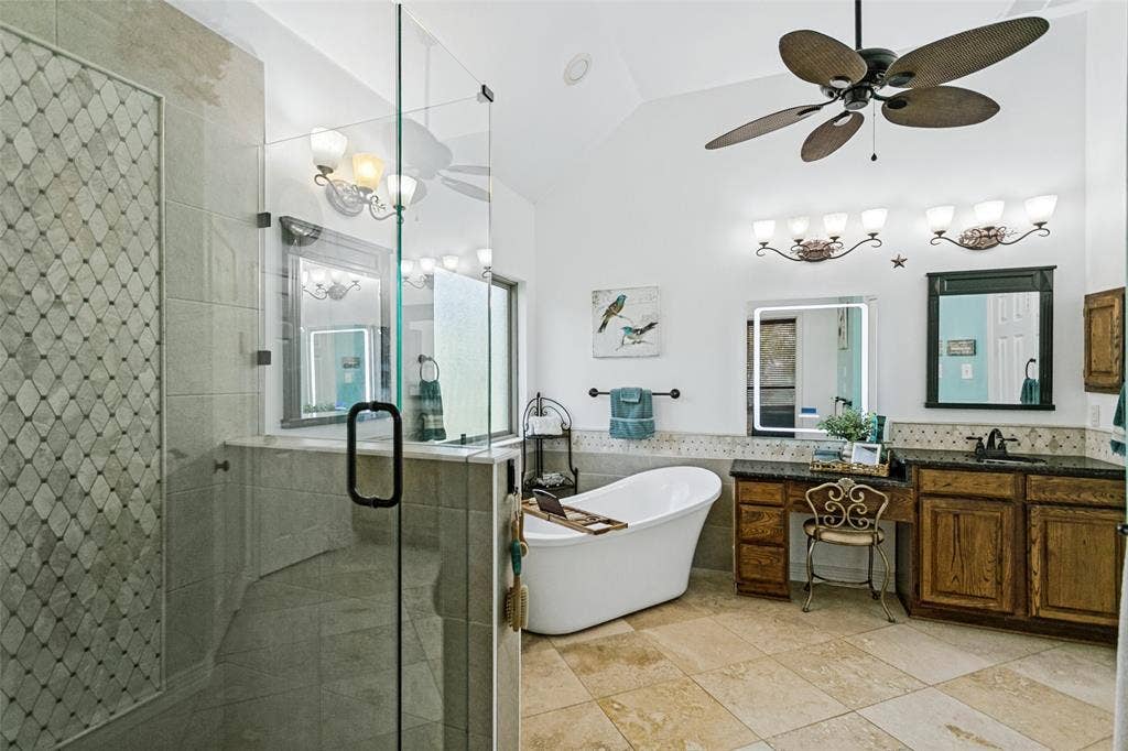 Beautiful ensuite Primary Bath with soaking tub, shower with frameless glass, and an illuminated mirror with bluetooth speakers built in.