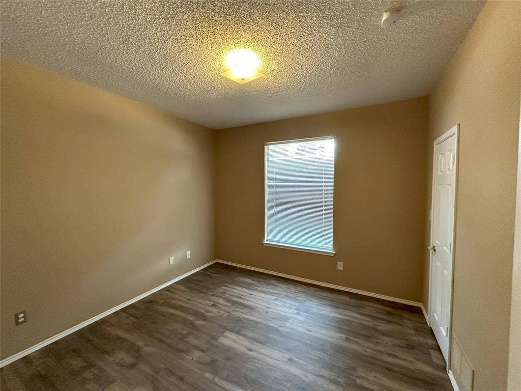 7800 Crestview Drive, Plano, TX 75024 Wood-finish flooring, neutral wall tones, white trim, and a ceiling-mounted light fixture