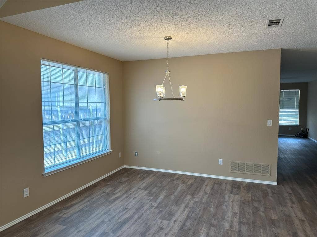 7800 Crestview Drive, Plano, TX 75024 Wood-finish flooring throughout, large window with blinds, and a contemporary chandelier