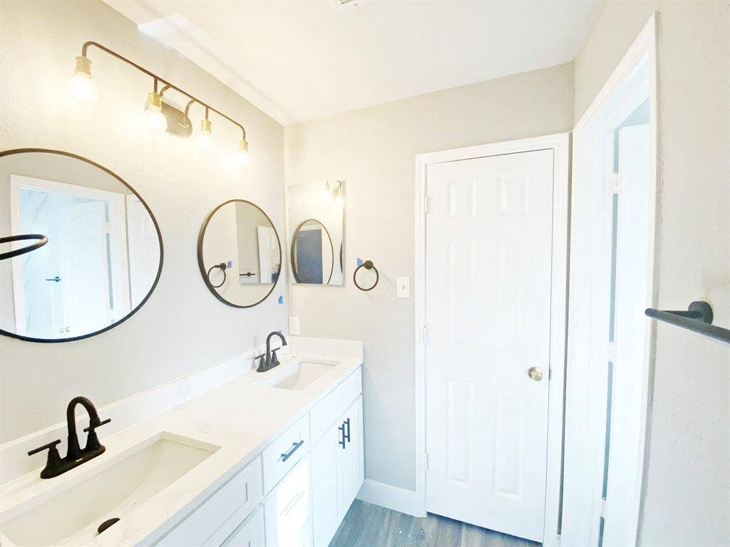 1700 Shiprock Drive, Plano, TX 75025 Bathroom featuring double sink vanity and wood-type flooring