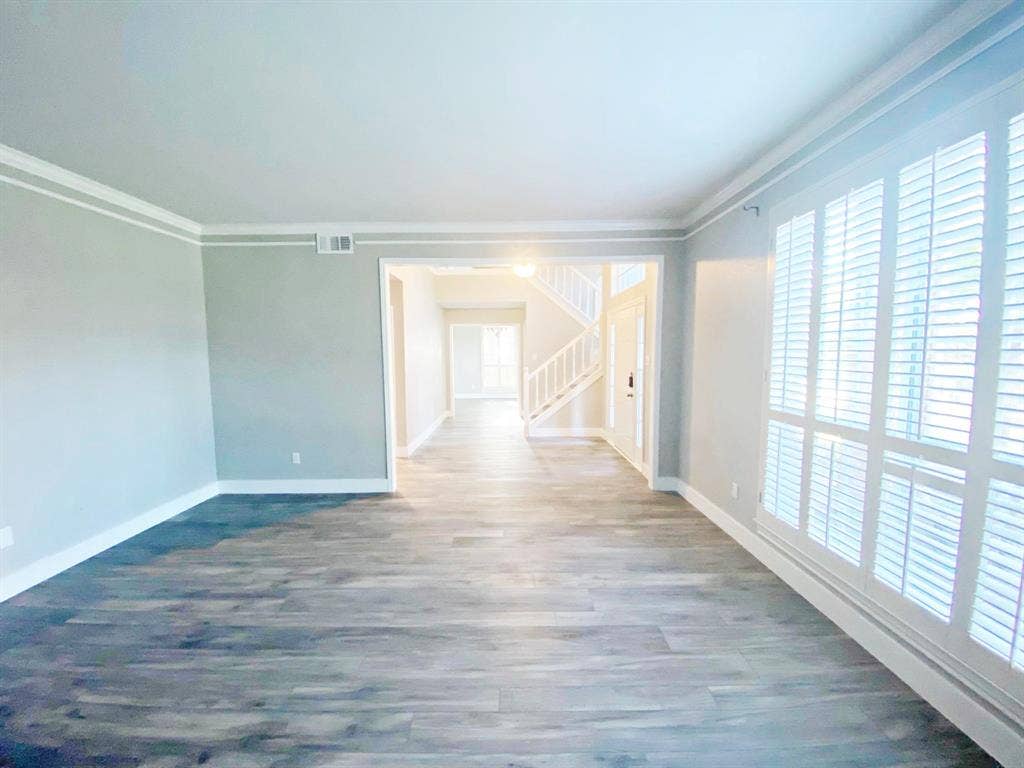 1700 Shiprock Drive, Plano, TX 75025 Spare room with hardwood / wood-style flooring and ornamental molding