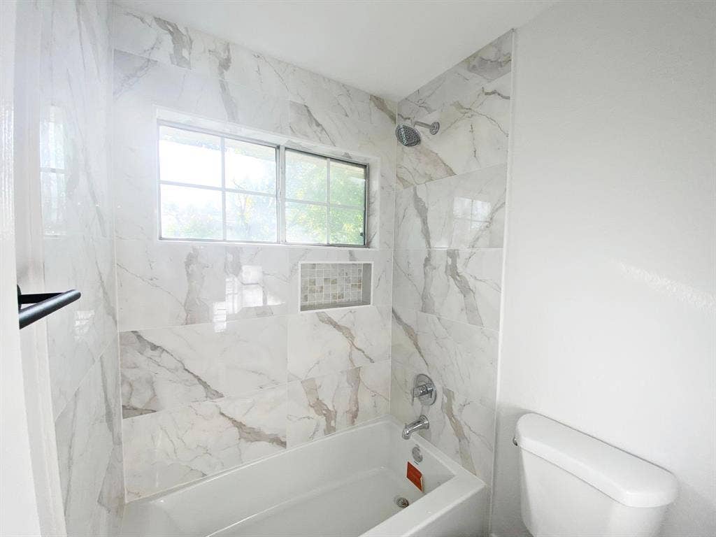 1700 Shiprock Drive, Plano, TX 75025 Bathroom with tiled shower / bath and toilet
