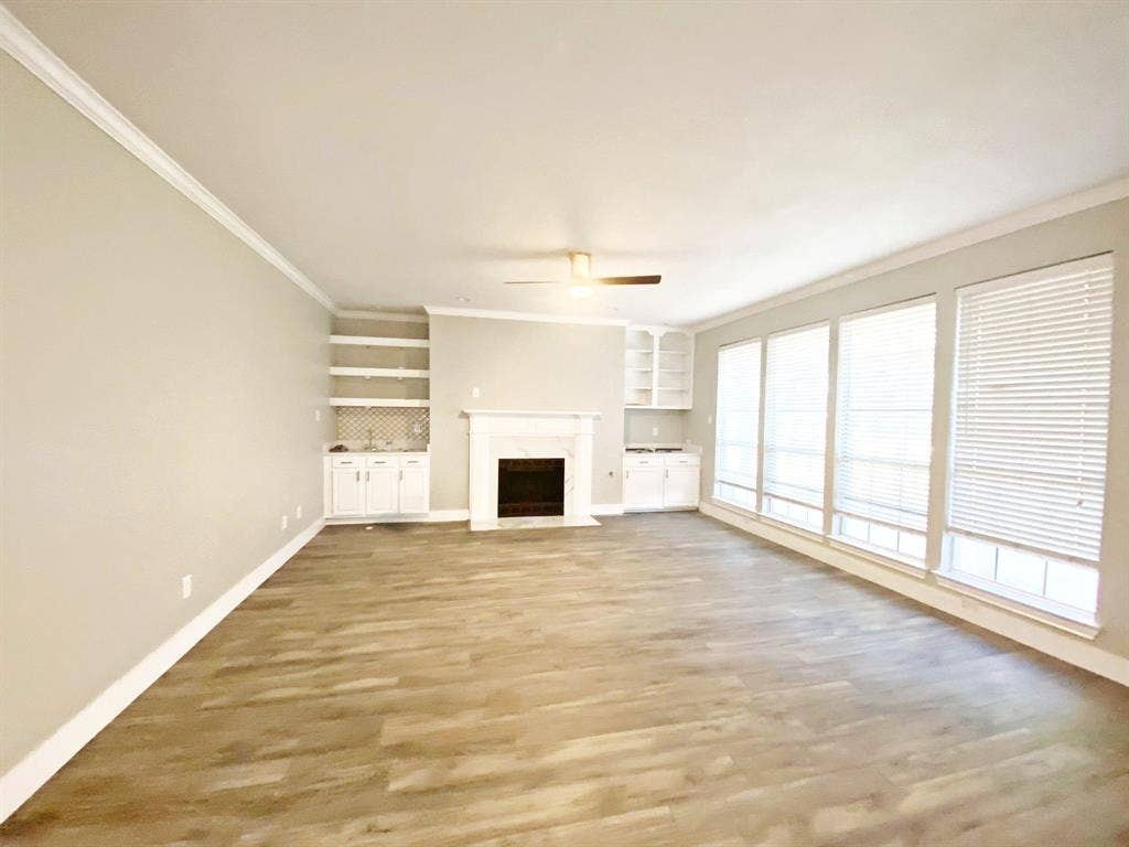 1700 Shiprock Drive, Plano, TX 75025 living room with hardwood / wood-style floors, ceiling fan, ornamental molding, and a premium fireplace