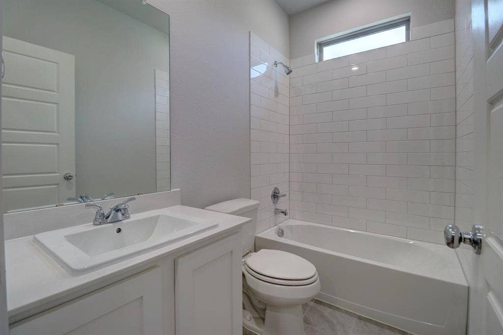 White subway tile shower surround with a built-in tub