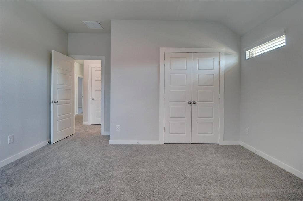 Wall-to-wall carpeting and white trim throughout
