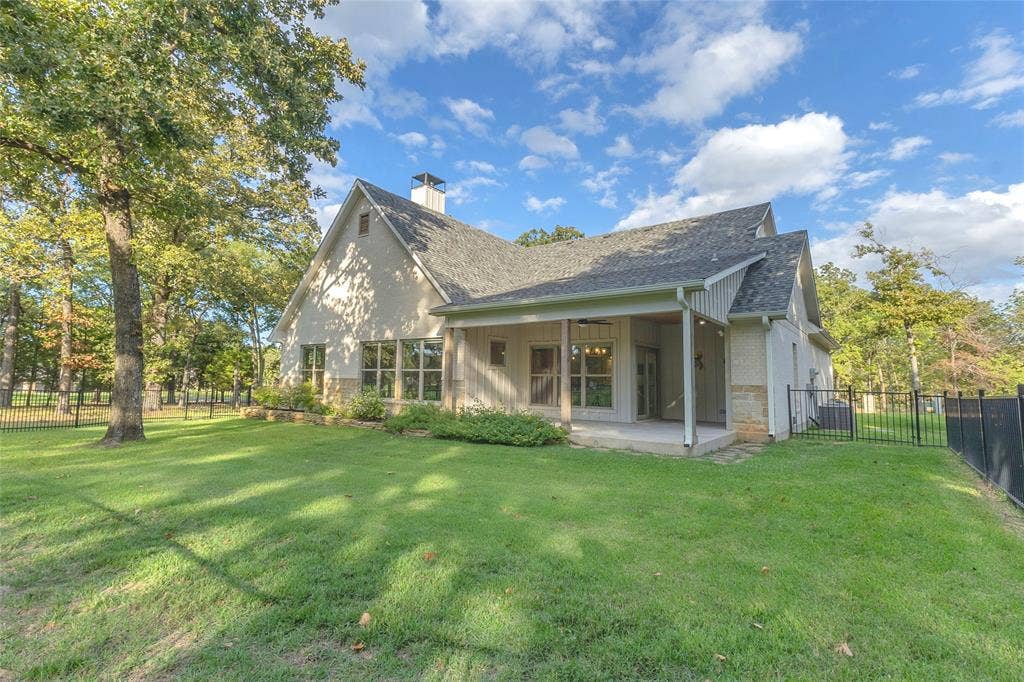 239 Colonial Drive, Mabank, TX 75156 Back of Home features great covered porch and wrought iron fenced yard
