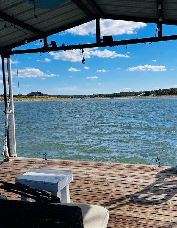 Waterfront deck with wood planking and overhead cover
