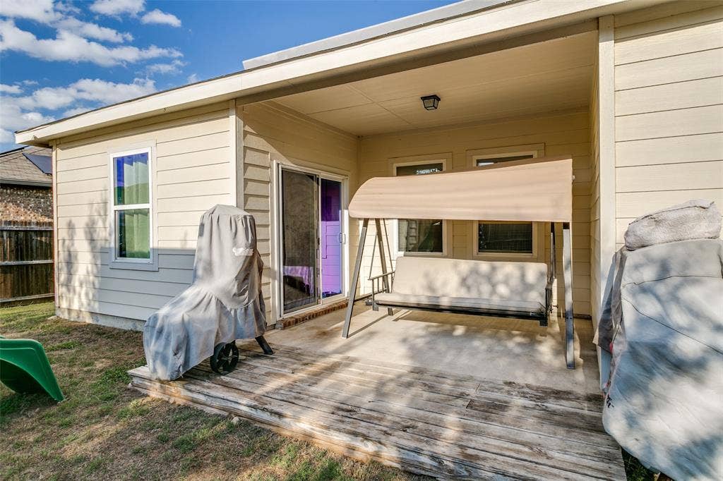 540 S Heights Drive, Crowley, TX 76036 Covered concrete patio with horizontal siding, sliding glass door access, and exterior wall-mounted lighting