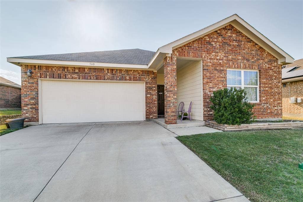 540 S Heights Drive, Crowley, TX 76036 Single-story brick exterior featuring a covered entryway, concrete driveway, and attached two-car garage