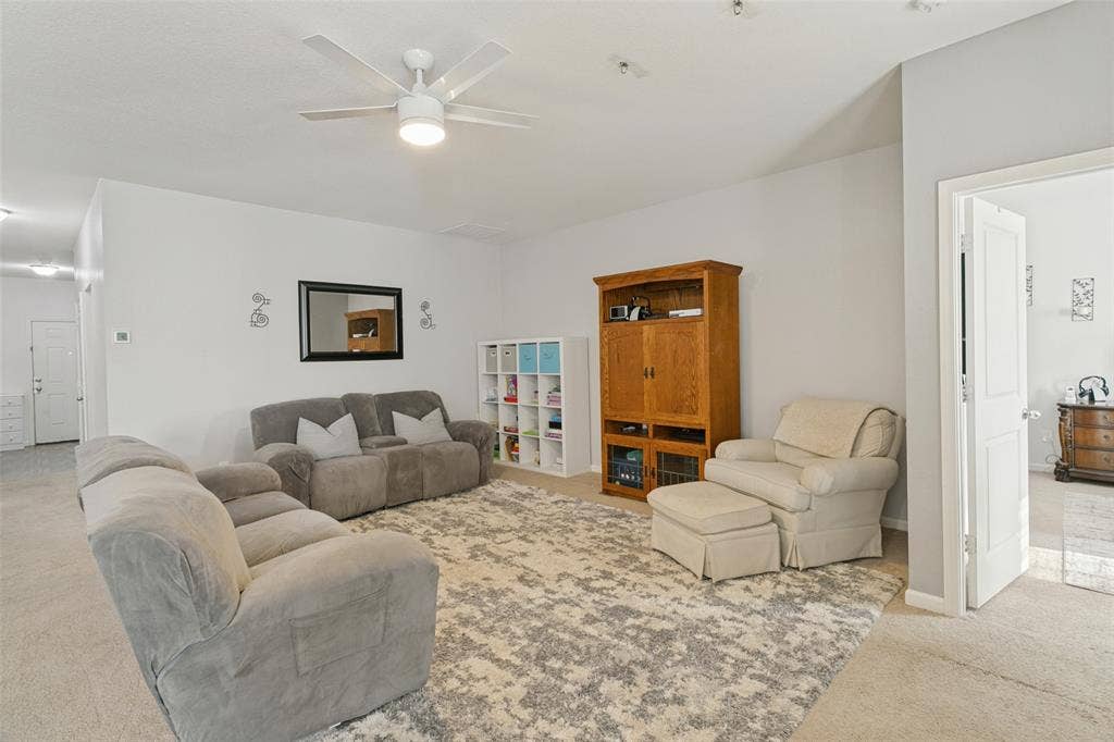 540 S Heights Drive, Crowley, TX 76036 Living area featuring neutral wall paint, carpeting, and a white ceiling fan with integrated lighting
