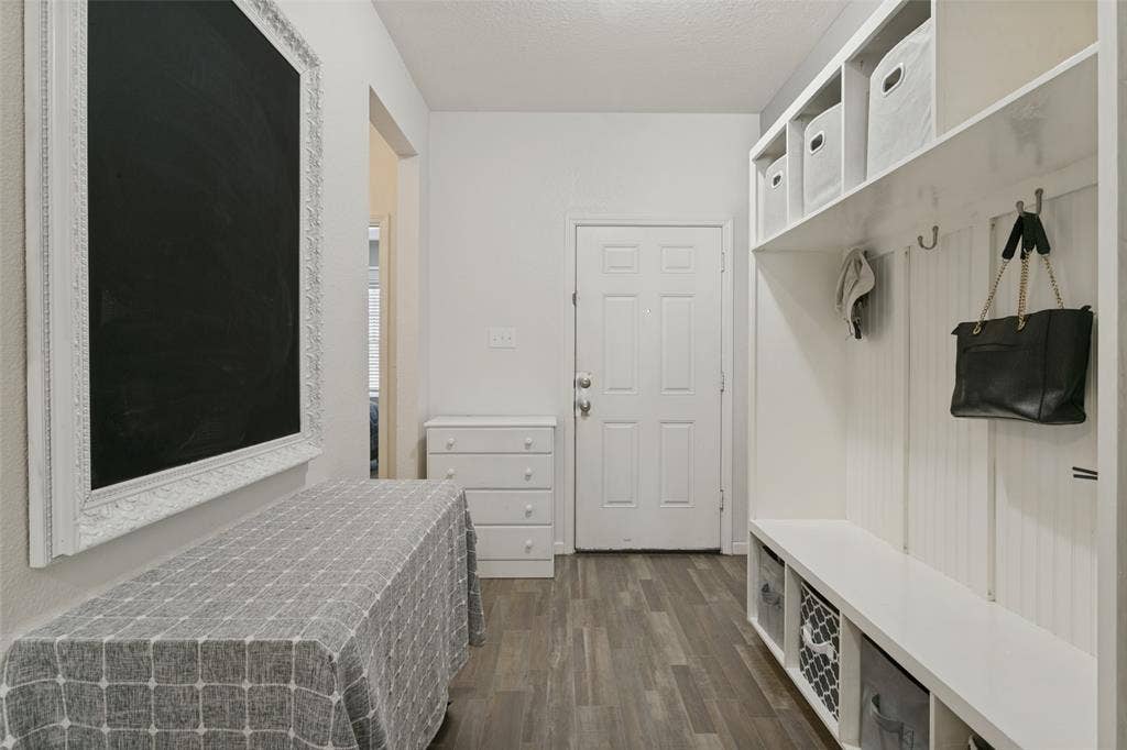 540 S Heights Drive, Crowley, TX 76036 Built-in white storage cabinetry with open cubbies and beadboard detailing, paired with wood-finish flooring