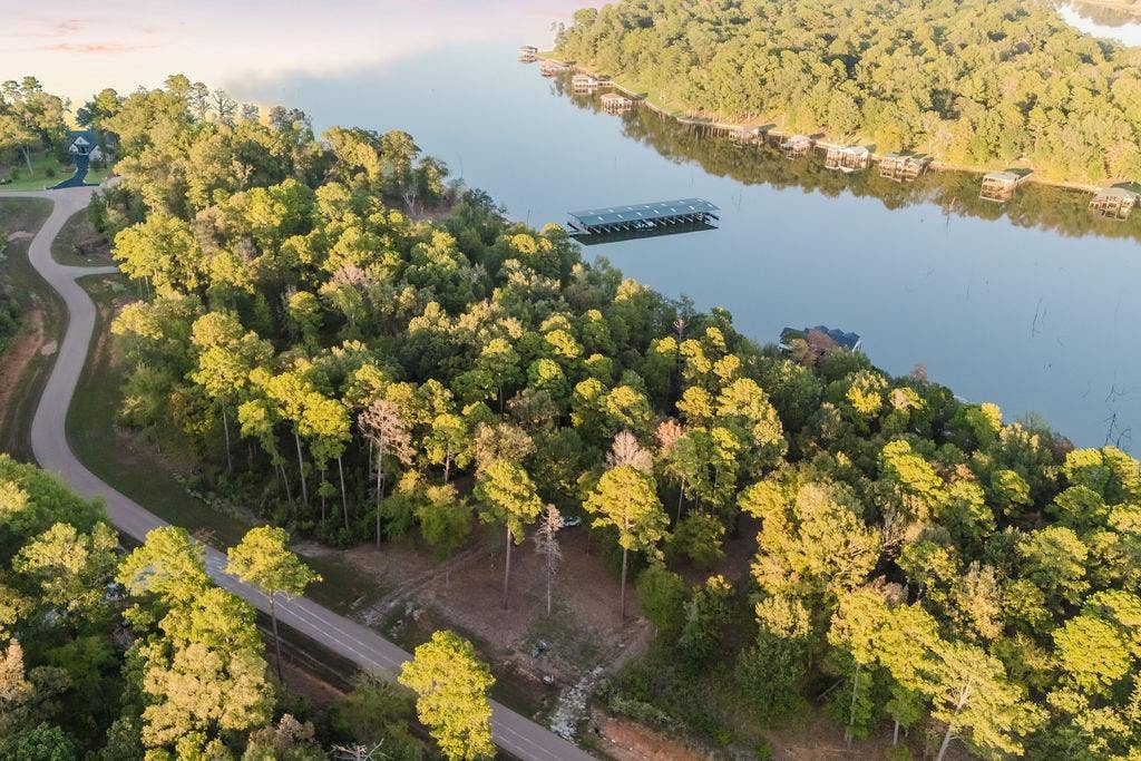 TBD Private Road 52416 Road, Leesburg, TX 75451 Wooded acreage with a winding paved road and lake frontage