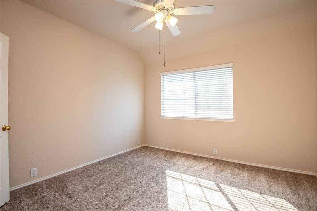 Neutral-toned walls complement the textured carpeting