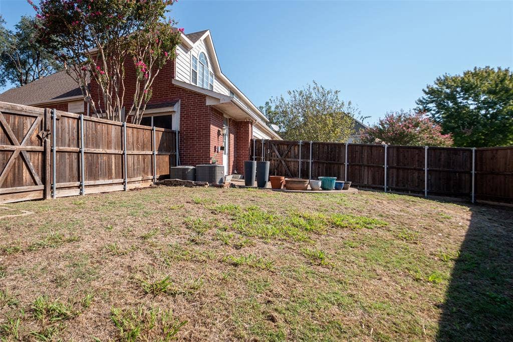 Enclosed backyard with wood privacy fencing