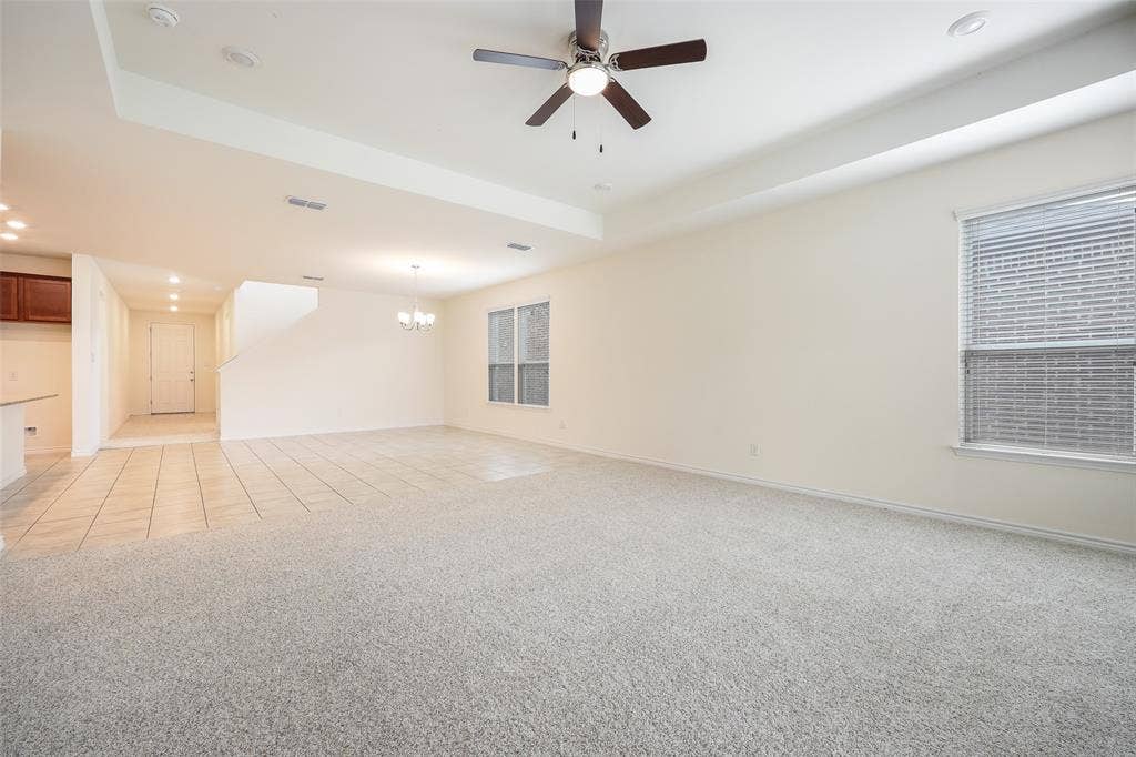 3681 Keechi Creek Drive, Celina, TX 75078 Tray ceiling with recessed lighting, central ceiling fan, neutral wall-to-wall carpeting, and tiled flooring