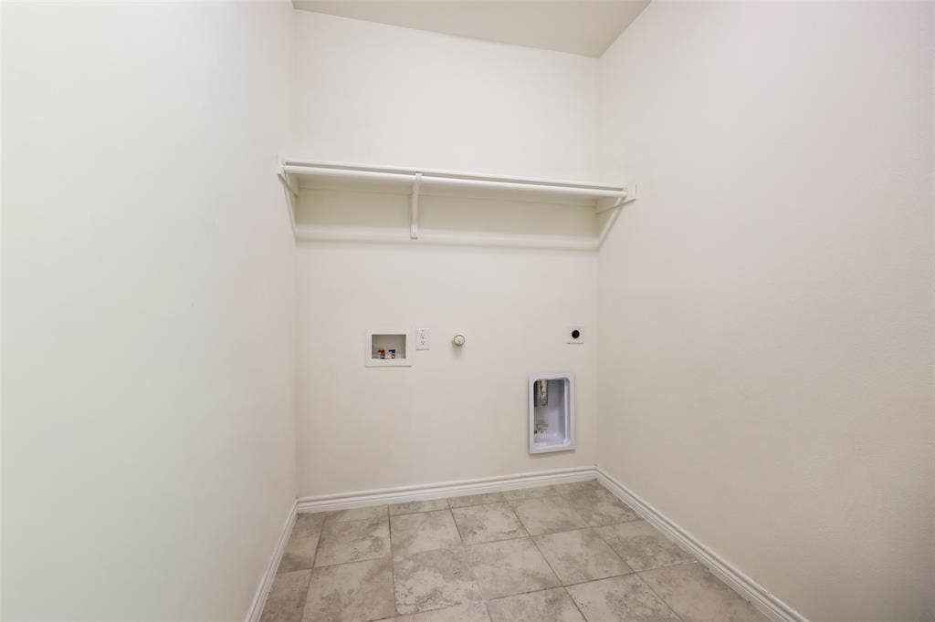 3681 Keechi Creek Drive, Celina, TX 75078 Utility area featuring neutral tile flooring, built-in overhead shelving, and dedicated hookups for laundry appliances