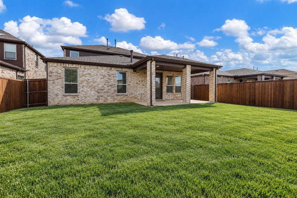 3681 Keechi Creek Drive, Celina, TX 75078 Virtually improved image. Brick exterior, covered rear patio, and expansive lawn enclosed by wood privacy fencing