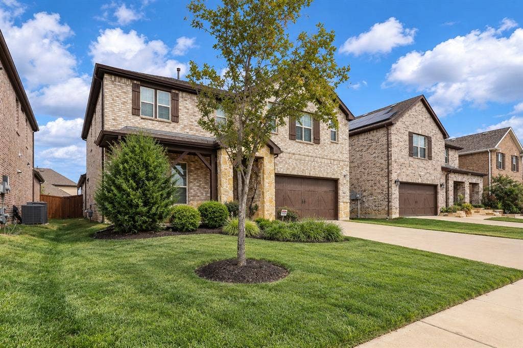 3681 Keechi Creek Drive, Celina, TX 75078 Virtually improved image. Two-story residence featuring a mixed brick and stone facade, covered front entryway with timber-style bracing, attached two-car garage, and manicured front lawn with mature landscaping