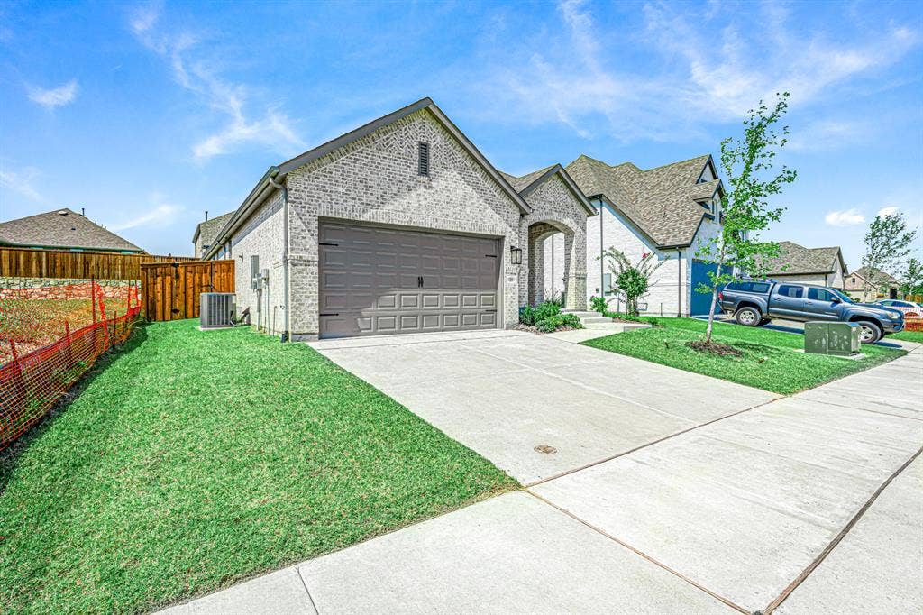 3800 Talisker Boulevard, Sherman, TX 75090 Brick exterior with a stone accent archway, featuring an attached two-car garage