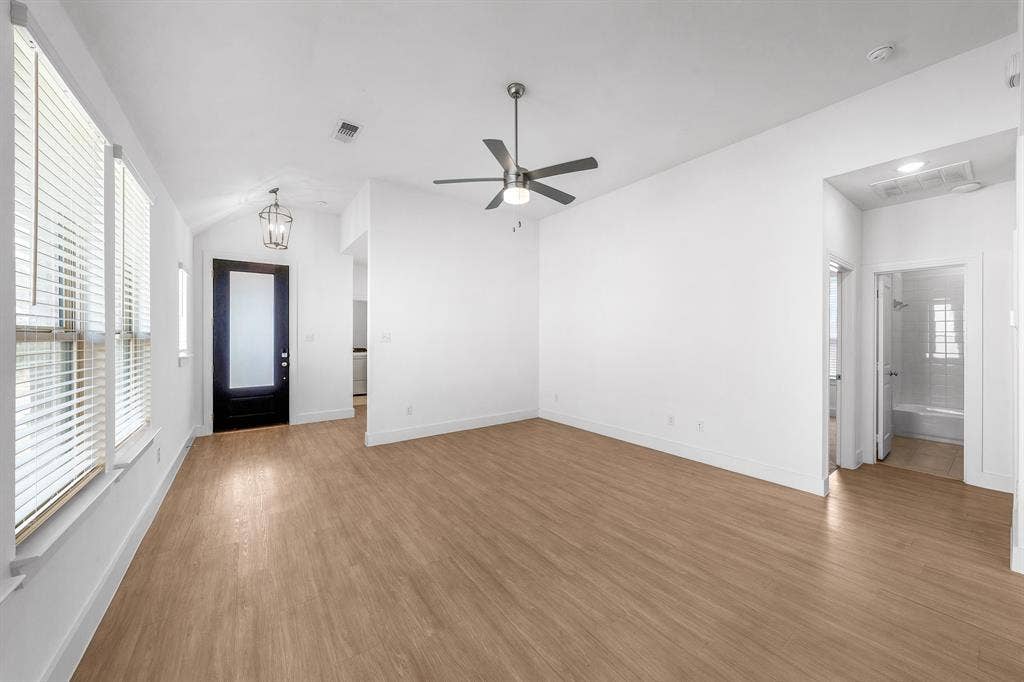 3800 Talisker Boulevard, Sherman, TX 75090 Spacious room featuring wood-finish flooring, a modern ceiling fan, and multiple windows with blinds