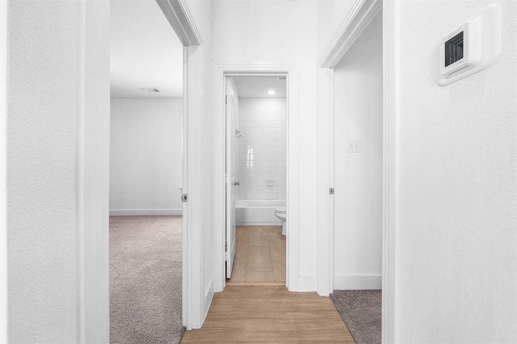 3800 Talisker Boulevard, Sherman, TX 75090 Wood-finish flooring, white subway tile shower surround, and a neutral carpeted room
