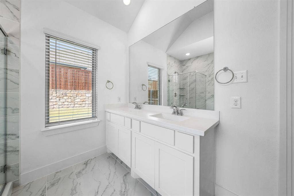3800 Talisker Boulevard, Sherman, TX 75090 Dual vanity with white cabinetry, integrated sinks, and polished chrome fixtures
