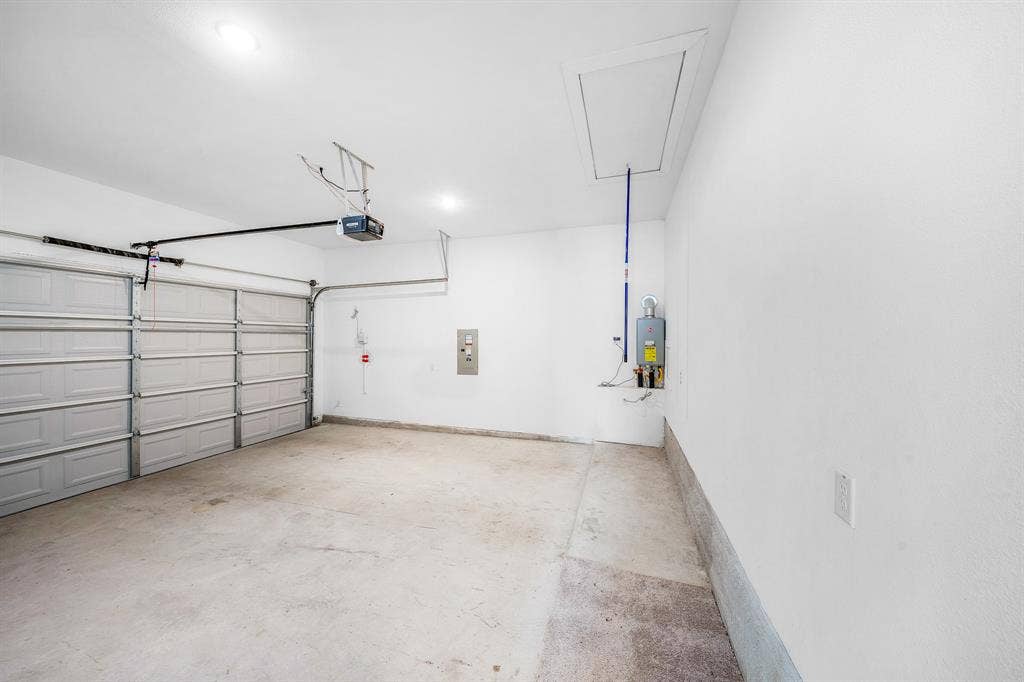 3800 Talisker Boulevard, Sherman, TX 75090 Attached garage with concrete flooring, two overhead doors, and an access panel