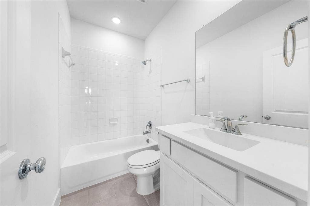 3800 Talisker Boulevard, Sherman, TX 75090 Full bathroom featuring a white tub, shower with subway tile surround, white vanity with integrated sink, and a large wall-mounted mirror