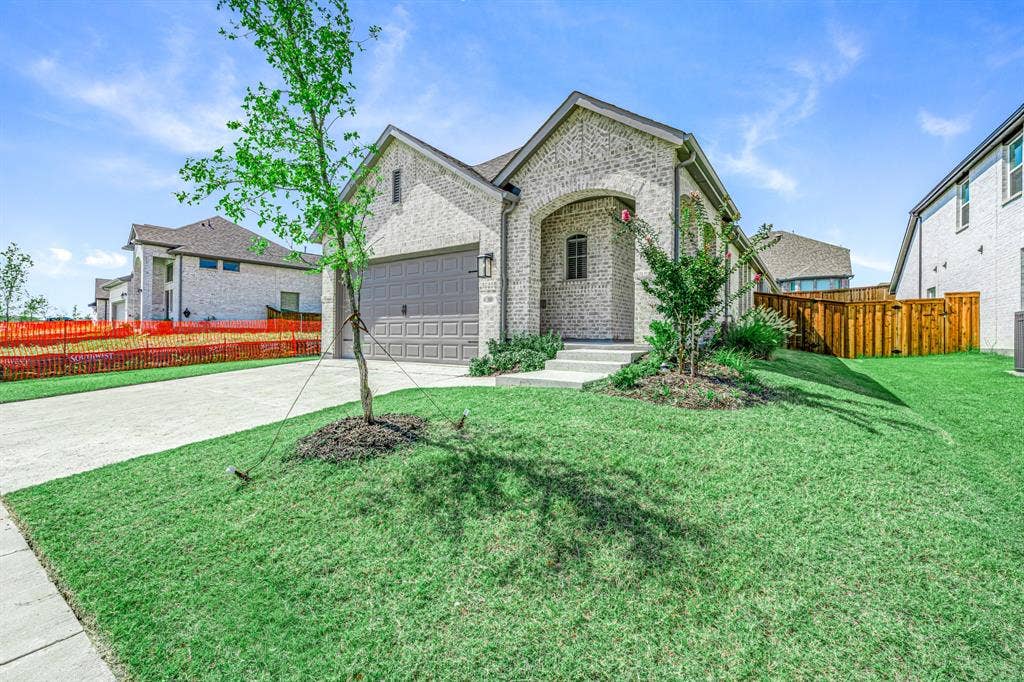 3800 Talisker Boulevard, Sherman, TX 75090 Brick exterior with arched entry, two-car garage, mature landscaping, and privacy fencing