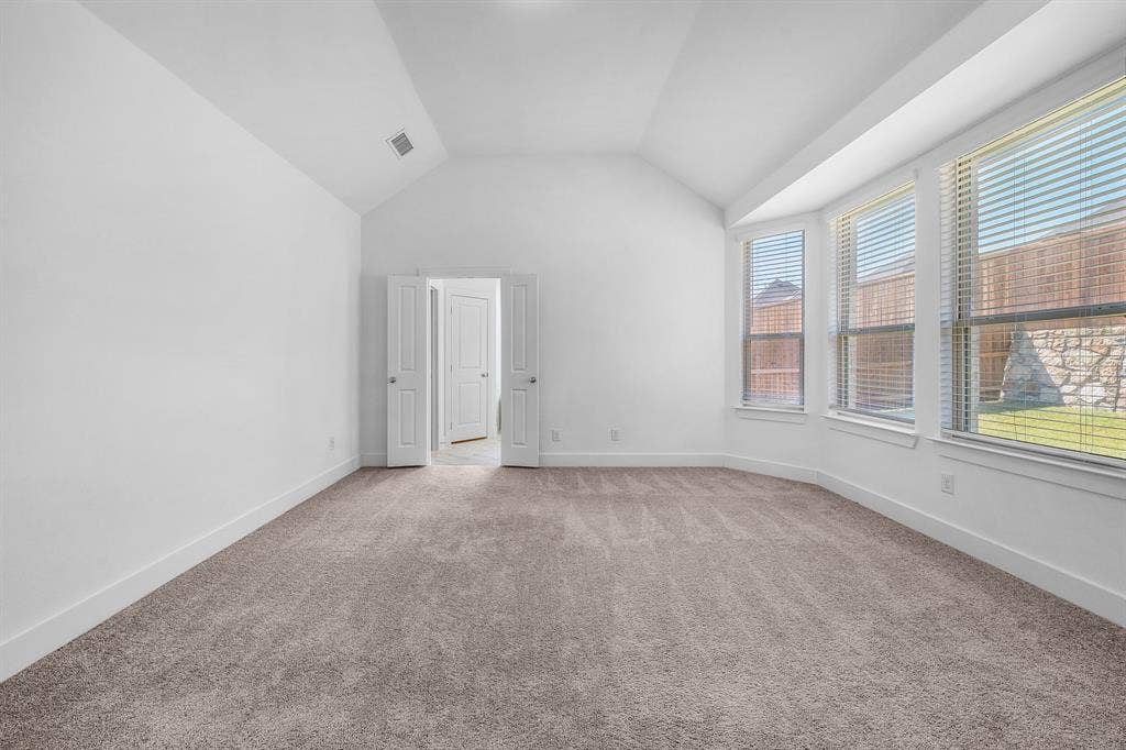 3800 Talisker Boulevard, Sherman, TX 75090 Vaulted ceiling, carpeted flooring, white walls, multiple windows with blinds, and white trim throughout