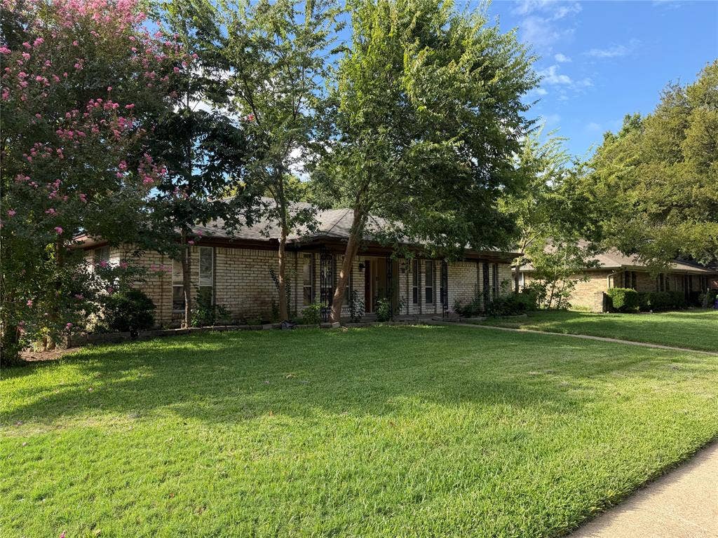 2408 Skiles Drive, Plano, TX 75075 Brick exterior with a gabled roof and mature trees