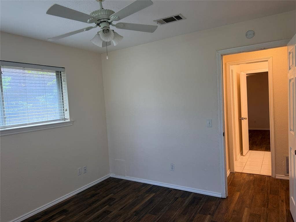 2408 Skiles Drive, Plano, TX 75075 Wood-finish flooring, neutral wall tones, window with blinds, and a ceiling fan with integrated lighting