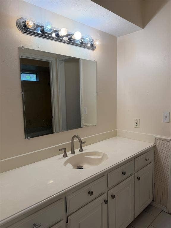2408 Skiles Drive, Plano, TX 75075 Vanity with an integrated sink, brushed nickel faucet, and white cabinetry