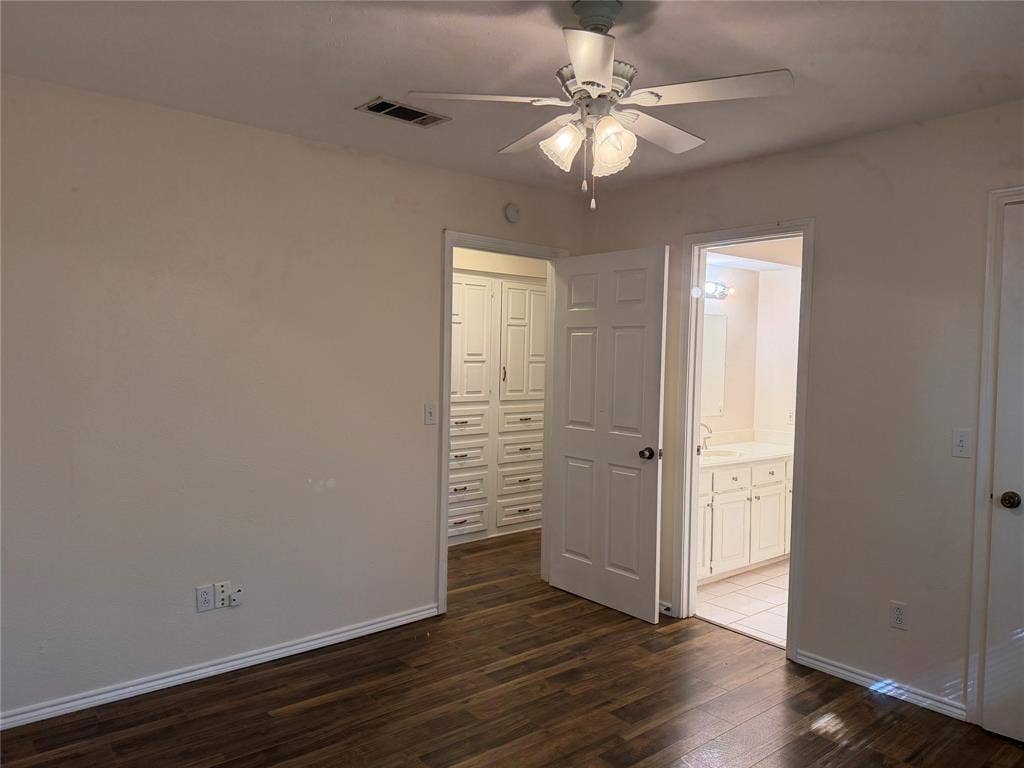 2408 Skiles Drive, Plano, TX 75075 Wood-finish flooring with white baseboards, featuring a ceiling fan with light fixture
