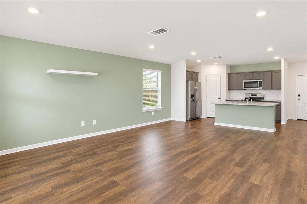 2316 French Street, Fate, TX 75189 Large open floorplan featuring the living and dining areas and the kitchen
