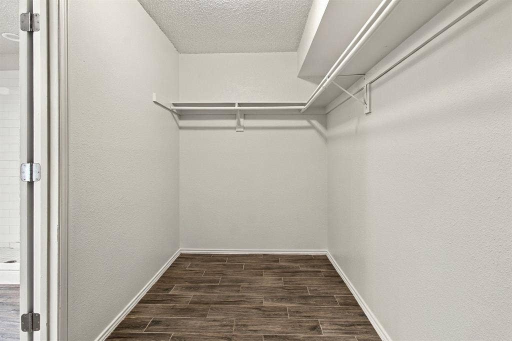 438 Blueridge Drive, Duncanville, TX 75137 Walk-in storage space featuring wood-finish flooring and dual-level metal shelving